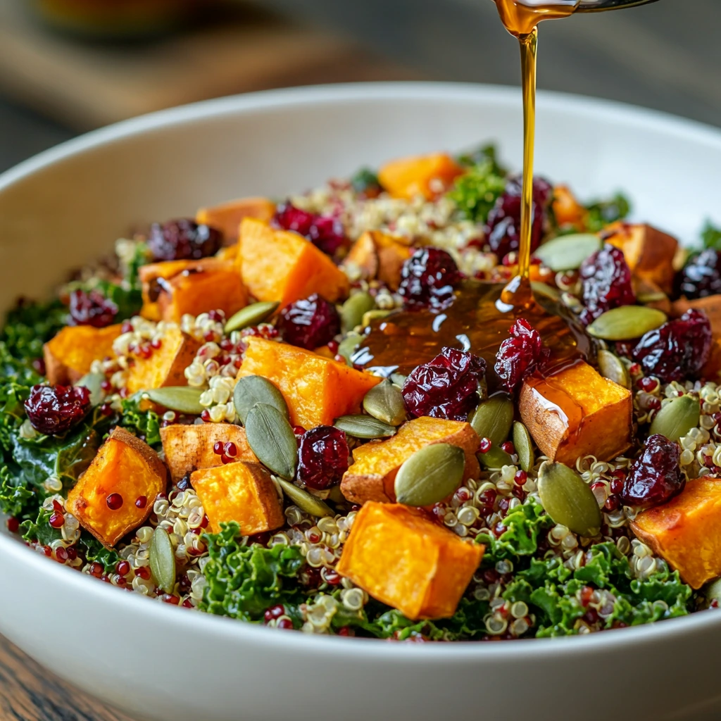 A hearty grain salad with quinoa, roasted sweet potatoes, cranberries, kale, and pumpkin seeds.