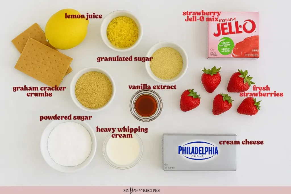 Overhead view of Strawberry Delight ingredients including graham crackers, cream cheese, strawberries, Jell-O mix, lemon, vanilla, and sugars.
